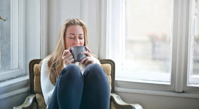 Woman relaxing with a hot beverage