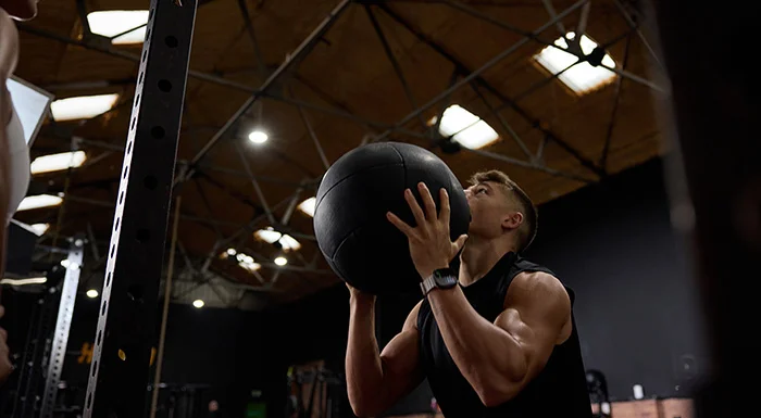 man exercising with weighted ball